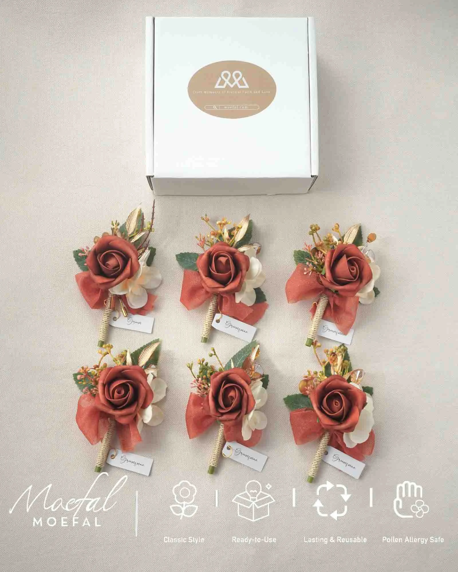 Six terracotta boutonnieres arranged neatly in front of their white packaging box.