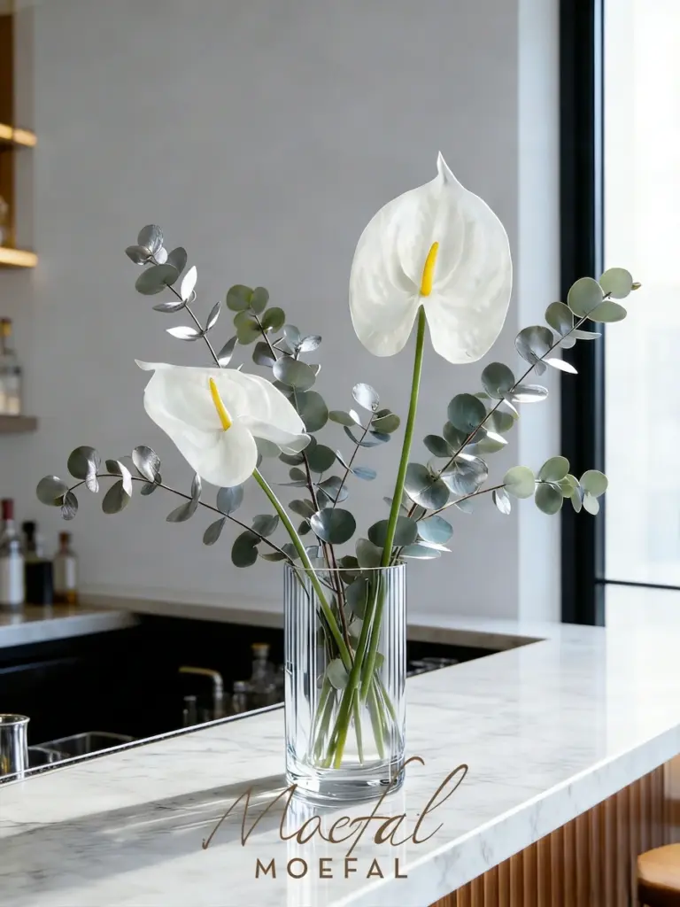 White faux anthuriums in a vase bringing the biophilic design trend indoors.