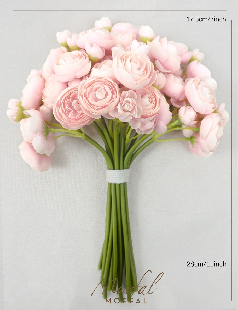 The full blush pink ranunculus bouquet is laid flat showing its height and width.