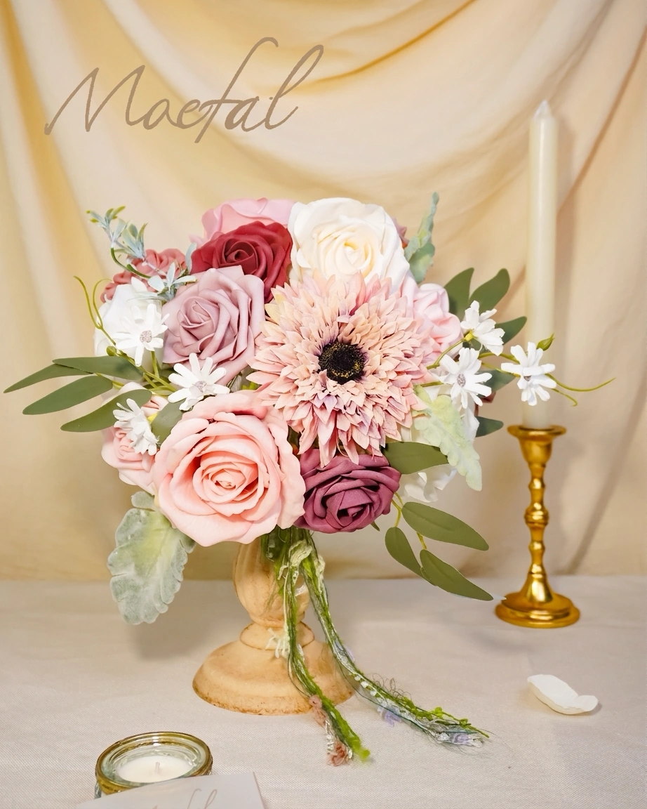 A rustic centerpiece using DIY spring wedding flowers next to a golden candlestick.