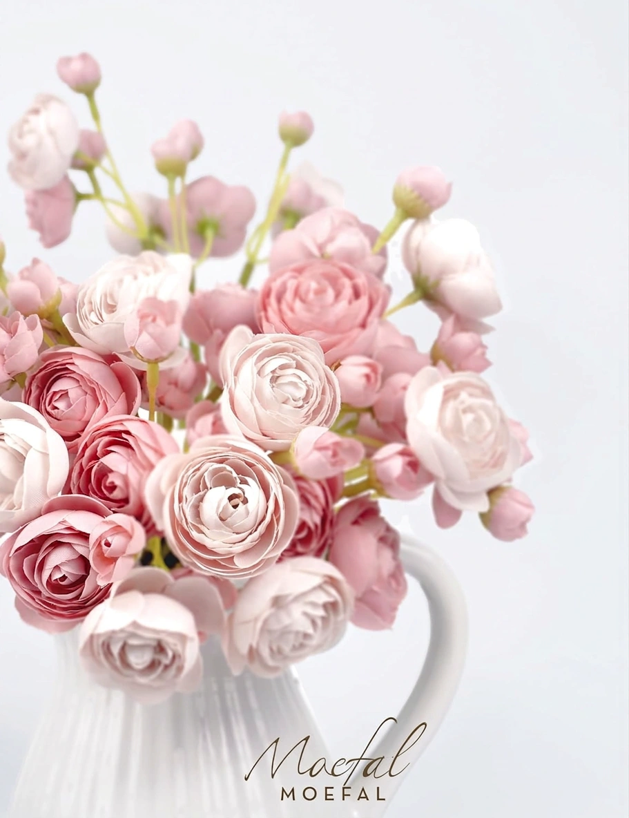 Close-up shot of dusty rose ranunculus blooms, highlighting their delicate, layered paper-thin petals.