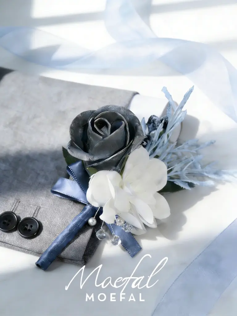 A stylish groom boutonniere with a silver rose and blue ribbon on a suit.