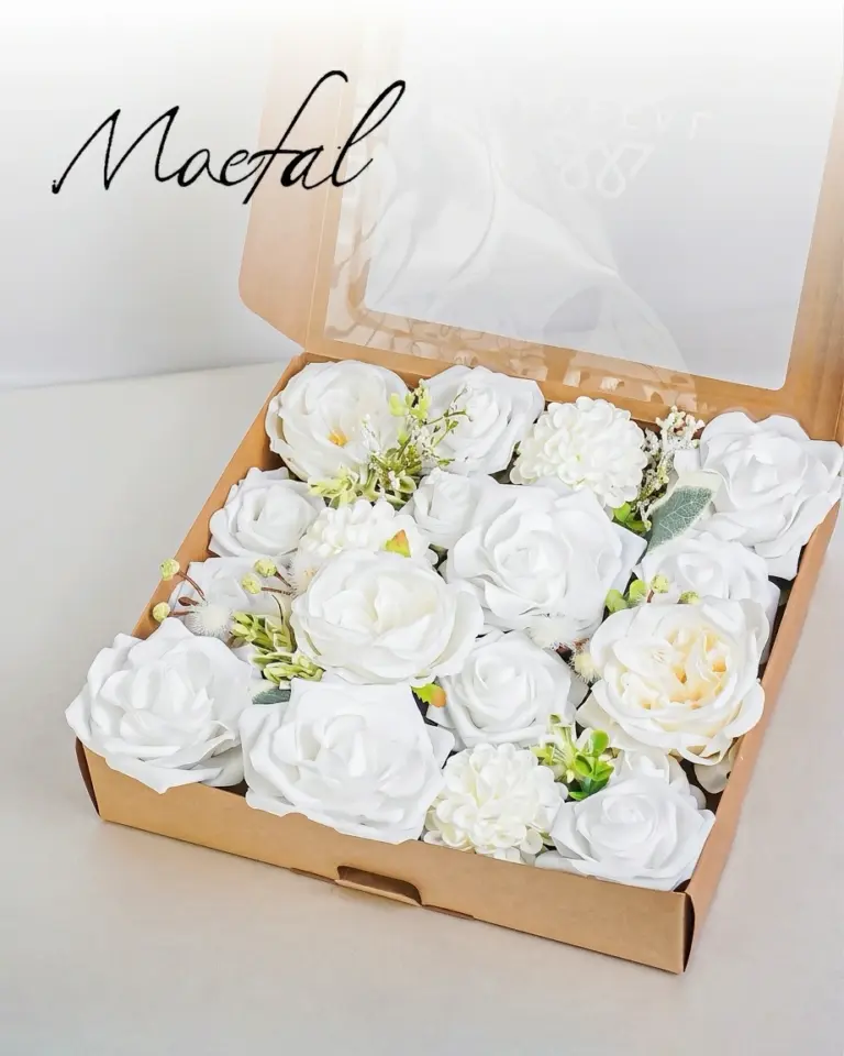 An open craft box filled with ivory and white artificial flowers for arrangements.