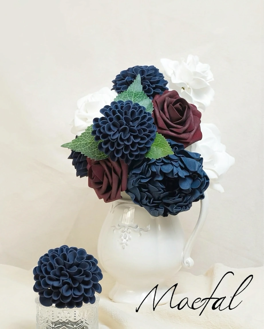 A faux flower bouquet for a navy blue wedding, combining dahlias with burgundy roses.