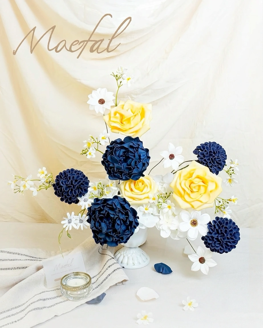 A vibrant centerpiece for a navy blue wedding, mixing faux peonies with yellow roses.