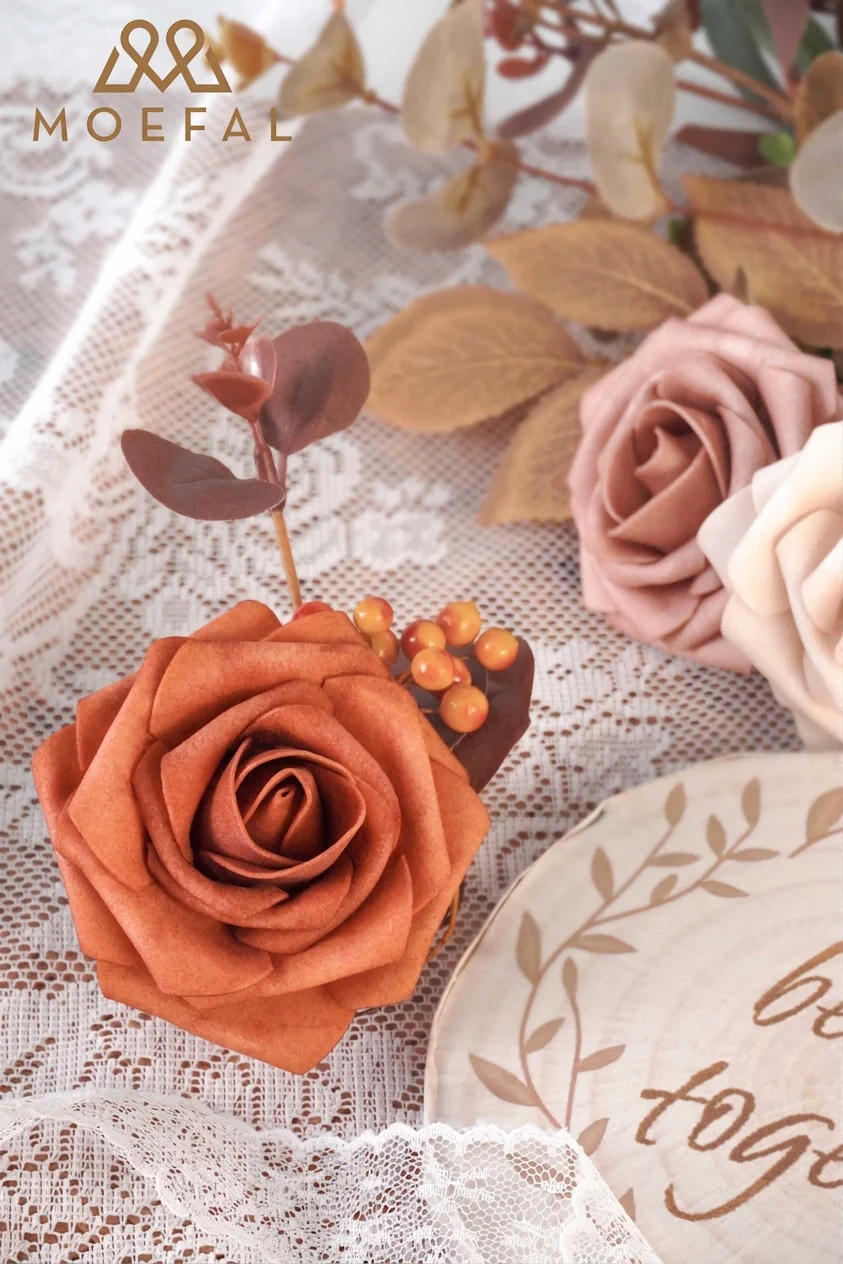 Macro shot of a burnt orange rose within a terracotta color palette arrangement.
