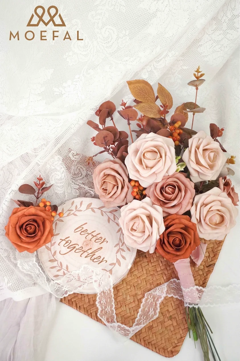A DIY wedding bouquet with a terracotta color palette resting on a lace surface.