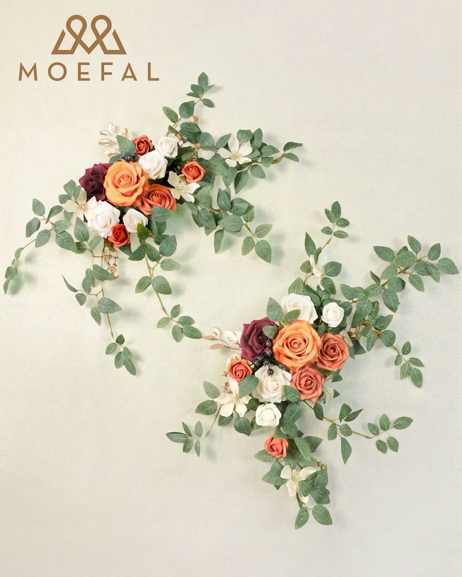 A pair of terracotta floral swags with long vines arranged for a wedding arch.