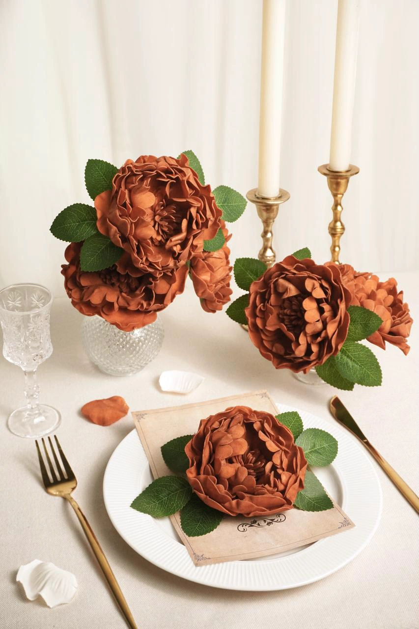 An elegant wedding table setting using terracotta peony flowers as centerpieces.