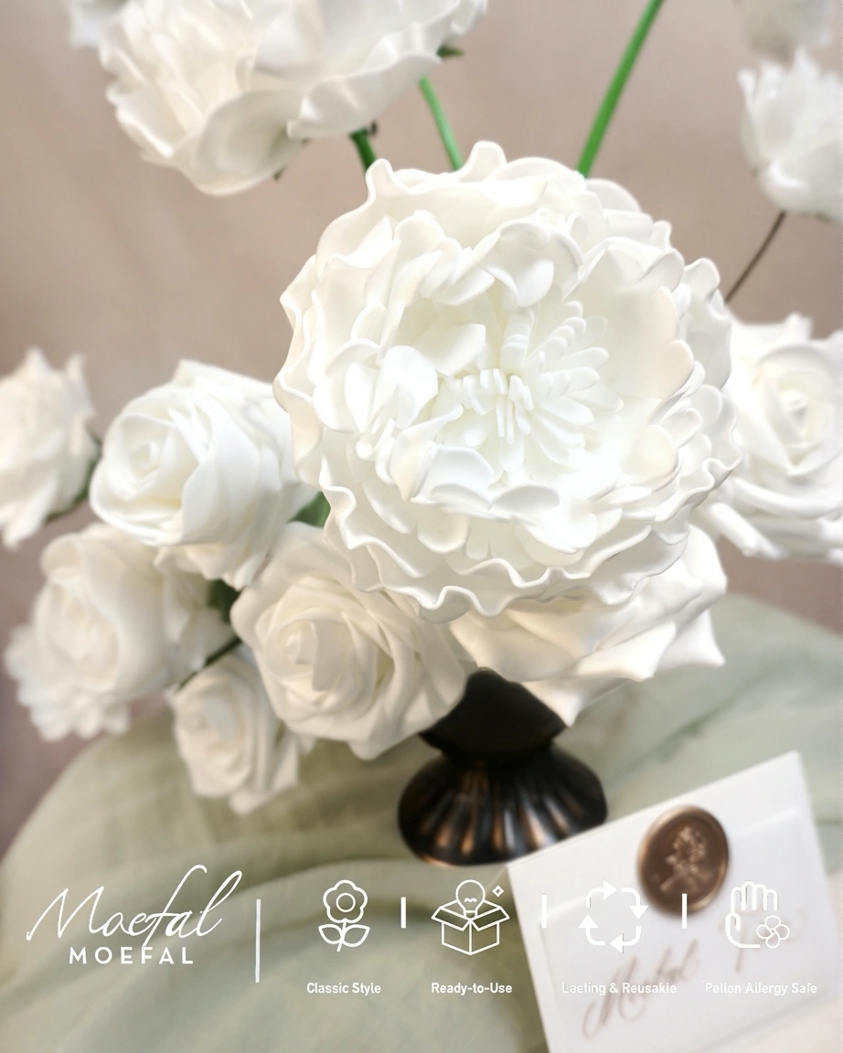 Closeup view highlighting the soft, ruffled petal texture of white peonies and roses.