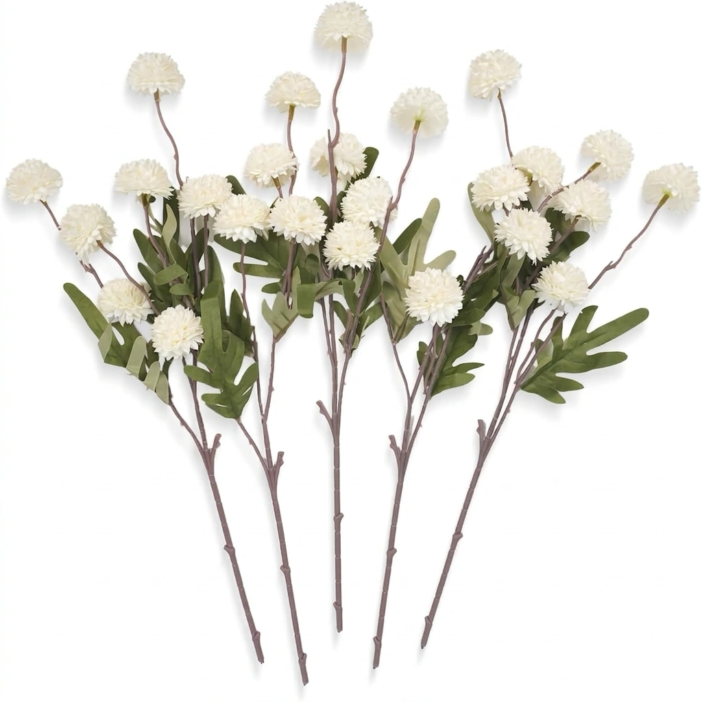Several individual stems of artificial white pompon mums laid out on a white background.