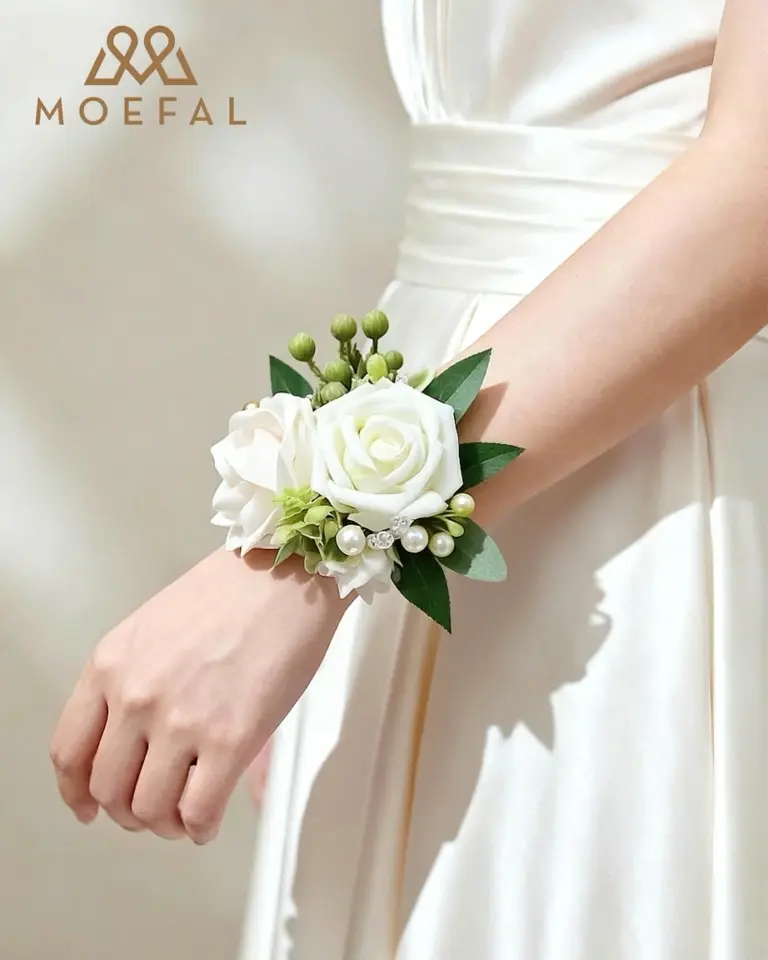 A bridesmaid wearing an ivory wrist corsage bracelet with her elegant satin dress.